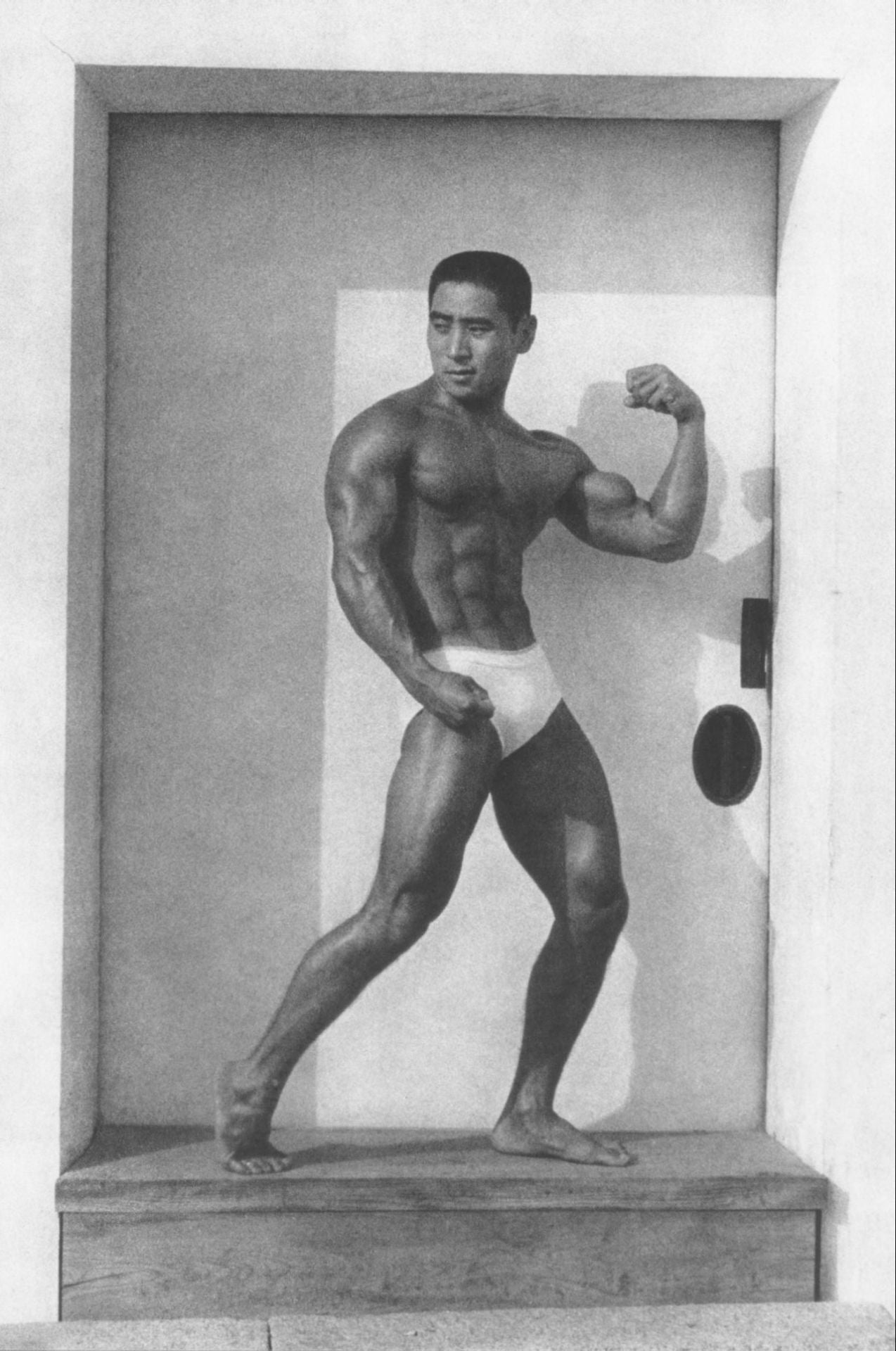 Tamotsu Yato Japanese Bodybuilder Poses in Doorway - 17" x 22" Fine Art Print